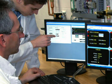 Technicians Looking Over Calibration Readings