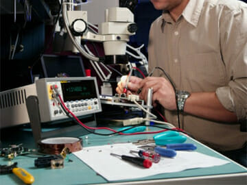 Technician Repairing a Circuit Board